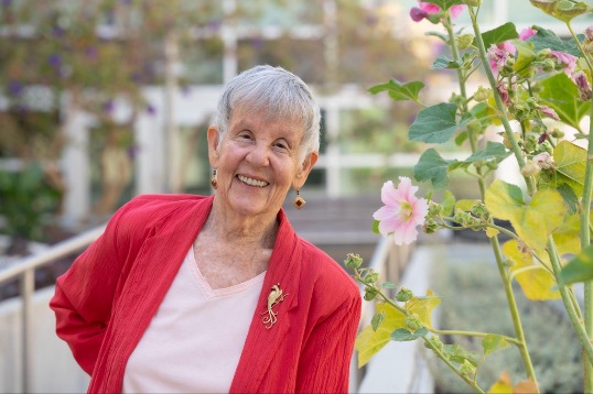 Older woman in red smiling