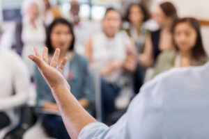 Speaker in front of a group of people